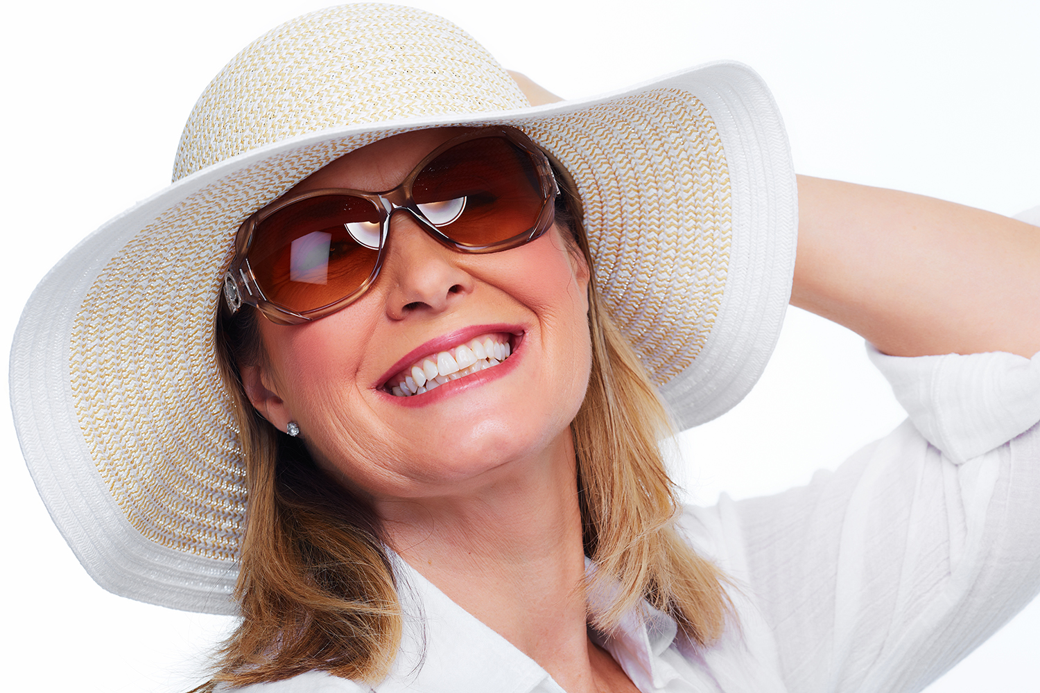 Happy senior woman in hat and sunglasses.