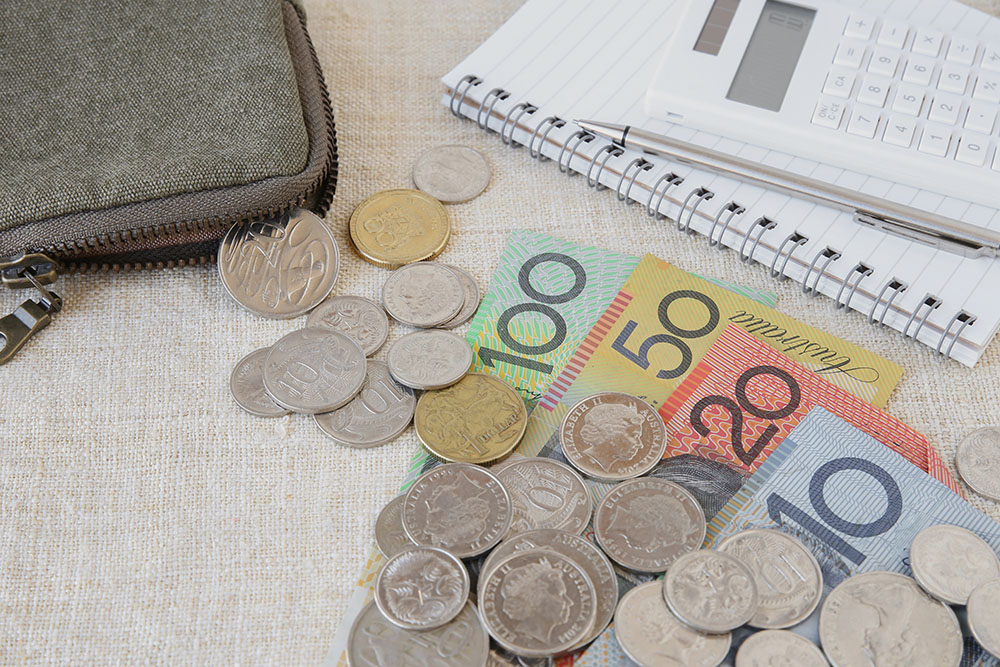 Australian money, AUD with calculator, notebook and small money
