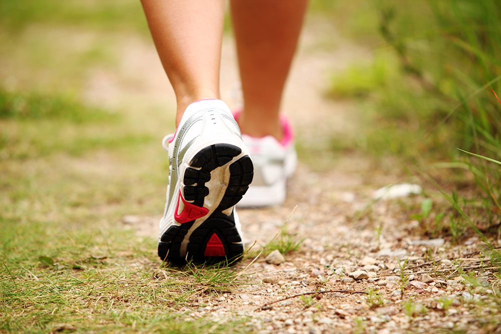 Female legs jogging on a trail