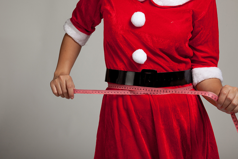 Asian Christmas girl in Santa Claus clothes diet with  measuring