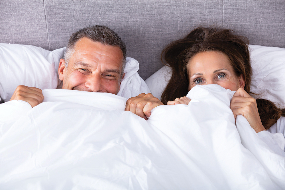 Couple Trying To Hide In Blanket